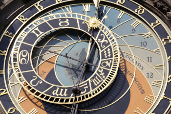 An astrological clock showing time and signs.